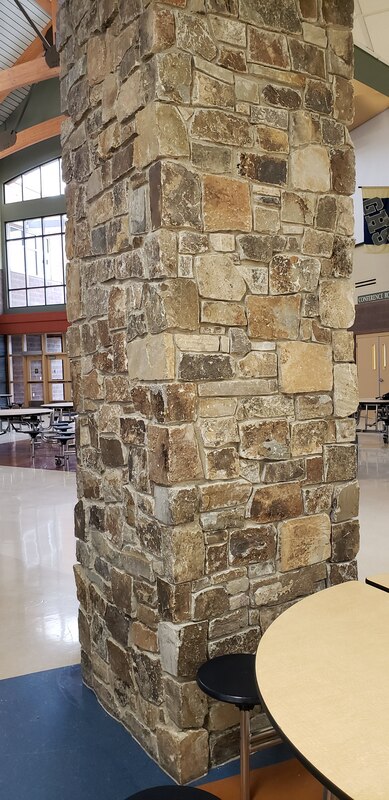 This image is Space. This pillar of rocks is taking up a certain amount of space in a big room. 